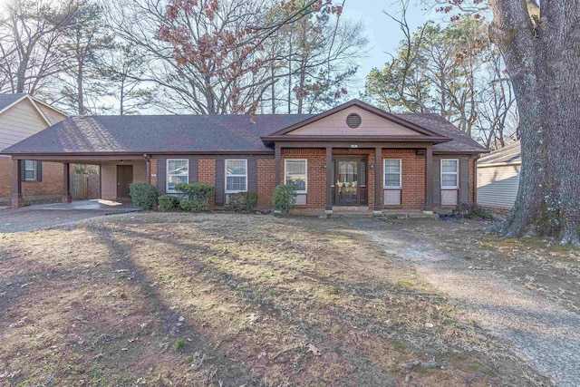 ranch-style home featuring a carport