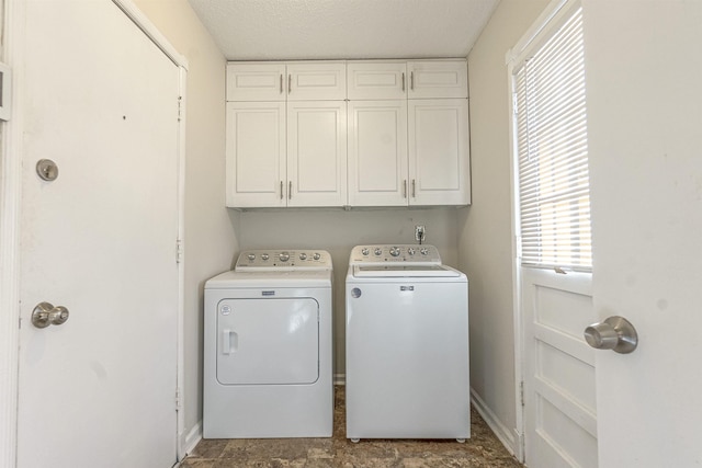 laundry area with cabinets and separate washer and dryer