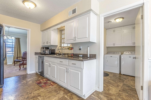 kitchen with sink, white cabinetry, washer and dryer, a textured ceiling, and stainless steel dishwasher