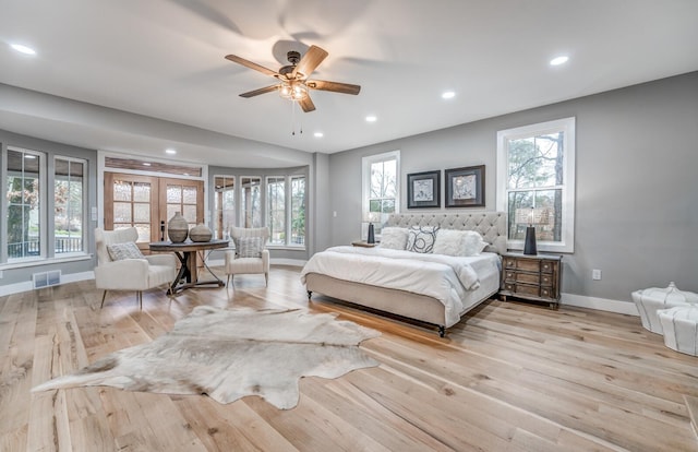 bedroom featuring light hardwood / wood-style flooring, french doors, and ceiling fan