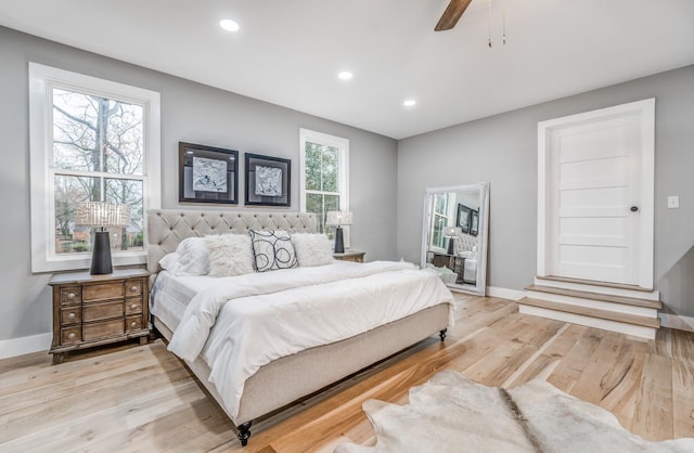 bedroom with ceiling fan and light hardwood / wood-style floors