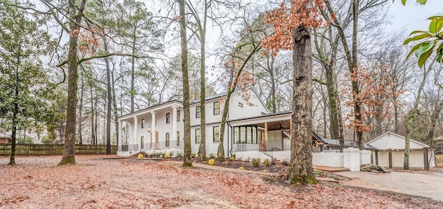 view of front of house with a garage, an outdoor structure, and a porch