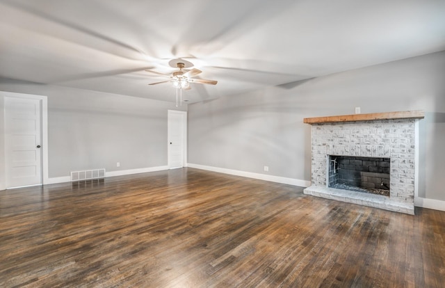 unfurnished living room with ceiling fan, dark hardwood / wood-style floors, and a fireplace