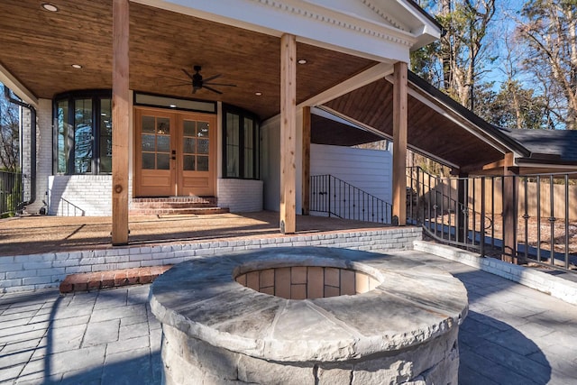 view of patio featuring french doors, ceiling fan, and an outdoor fire pit