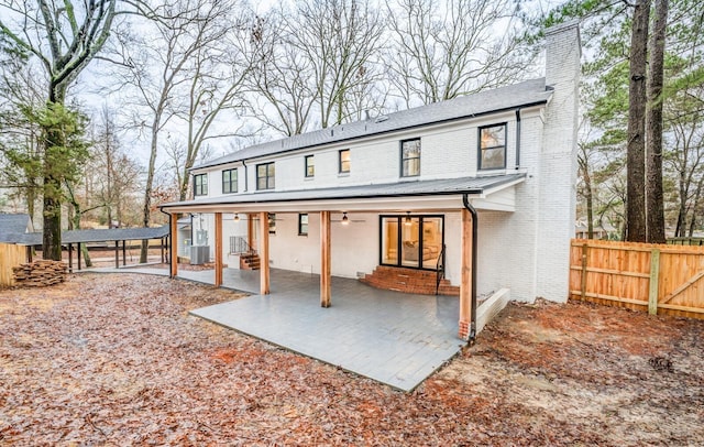 rear view of house featuring a patio and cooling unit