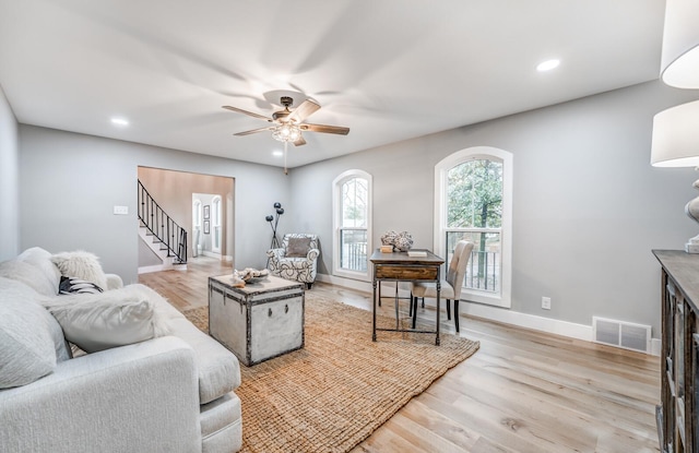 living room with ceiling fan and light hardwood / wood-style flooring