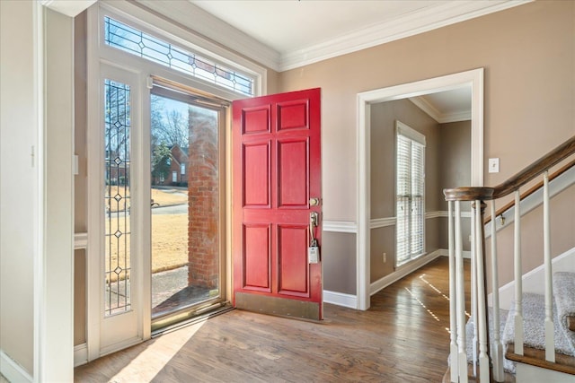 foyer with dark wood-type flooring and ornamental molding