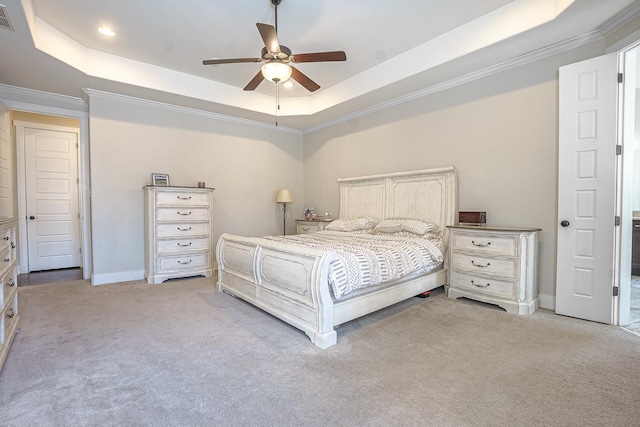 bedroom featuring a raised ceiling, light colored carpet, and ceiling fan