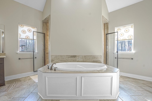 bathroom with lofted ceiling, plus walk in shower, and vanity