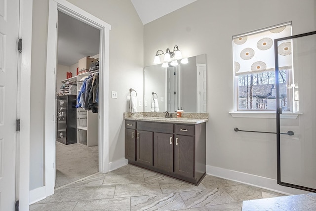 bathroom with vanity and vaulted ceiling