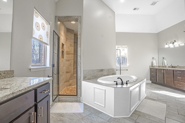 bathroom with shower with separate bathtub and vanity