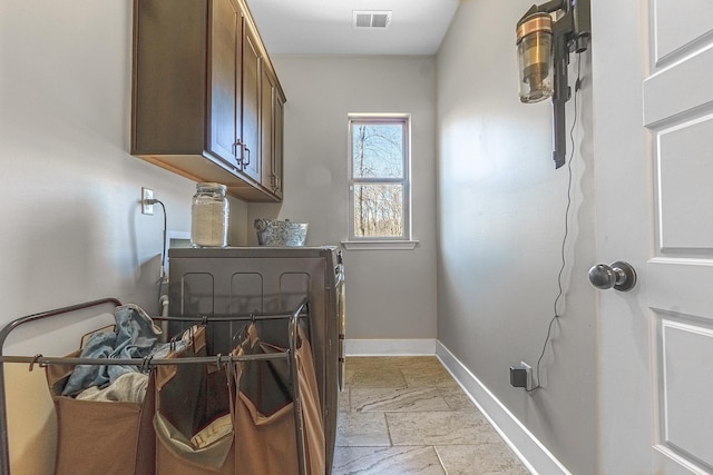 laundry room featuring washer / clothes dryer and cabinets