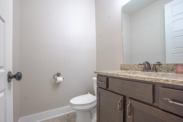 bathroom with tile patterned flooring, vanity, and toilet