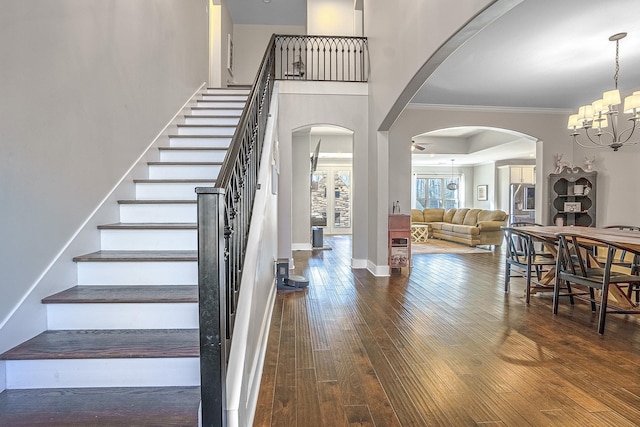 interior space with ornamental molding, dark hardwood / wood-style floors, and a chandelier