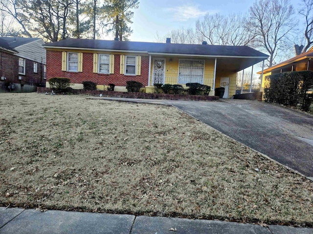 ranch-style home with a front yard and a carport