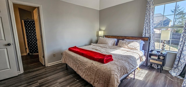 bedroom featuring dark hardwood / wood-style floors and multiple windows