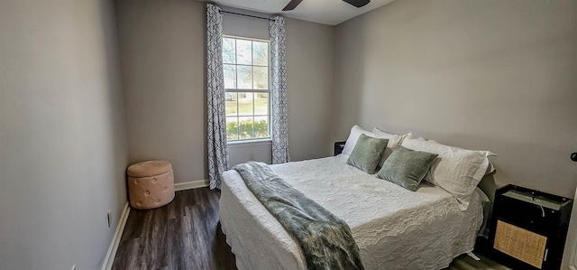 bedroom featuring multiple windows, dark wood-type flooring, and ceiling fan