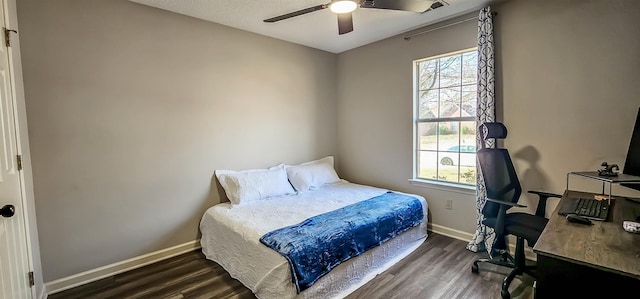 bedroom with multiple windows, dark hardwood / wood-style floors, and ceiling fan