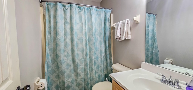 bathroom with vanity, a shower with shower curtain, and toilet