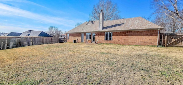 back of property featuring a yard and central air condition unit