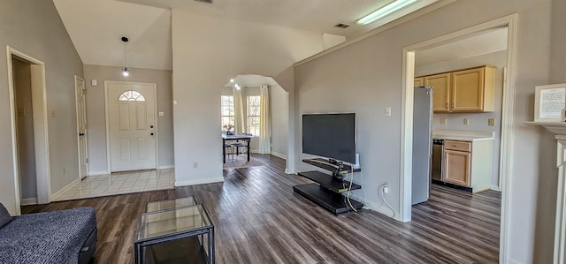 entryway with high vaulted ceiling and dark hardwood / wood-style flooring