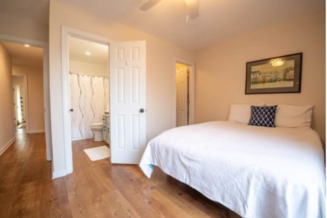 bedroom with wood-type flooring, ceiling fan, and ensuite bathroom