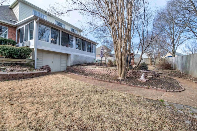 view of side of property featuring a yard and a sunroom