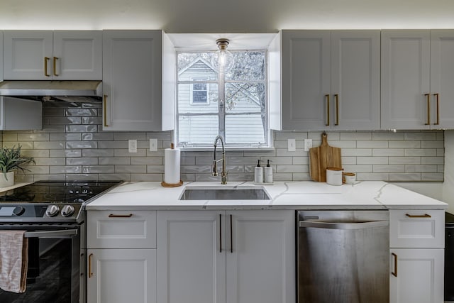 kitchen with stainless steel appliances, tasteful backsplash, light stone countertops, and sink