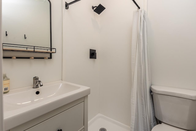 bathroom featuring walk in shower, vanity, and toilet