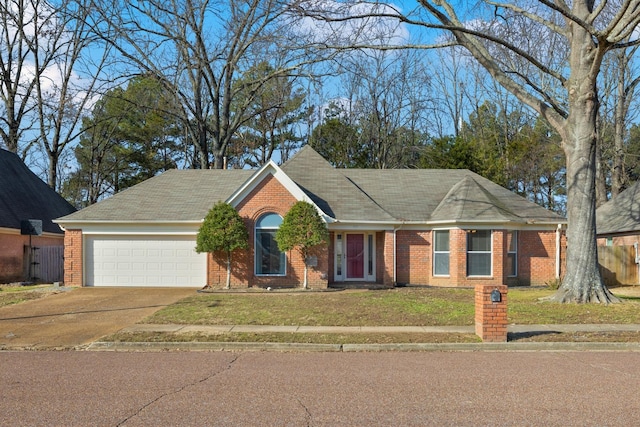 view of front facade featuring driveway, brick siding, an attached garage, and a front yard