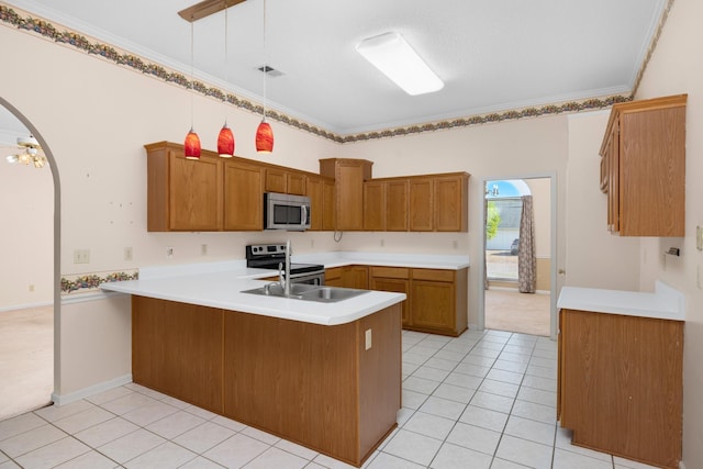 kitchen featuring light tile patterned flooring, decorative light fixtures, ornamental molding, appliances with stainless steel finishes, and kitchen peninsula