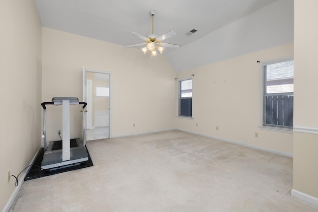 workout room with lofted ceiling, light colored carpet, and ceiling fan