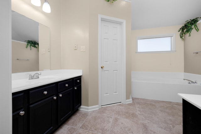 bathroom with tile patterned floors, vanity, and a bath