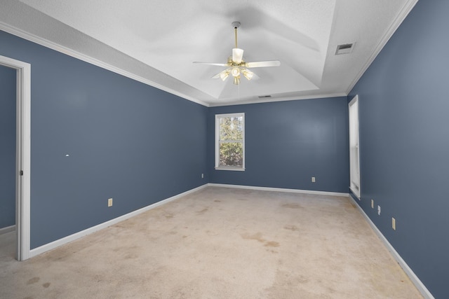 carpeted spare room with a raised ceiling, ornamental molding, a textured ceiling, and ceiling fan