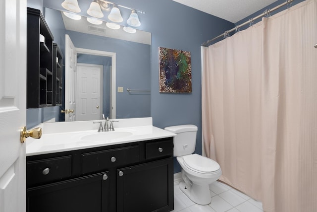 bathroom with tile patterned flooring, vanity, and toilet