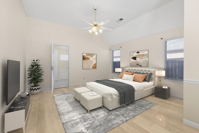 bedroom featuring multiple windows, vaulted ceiling, visible vents, and light wood finished floors