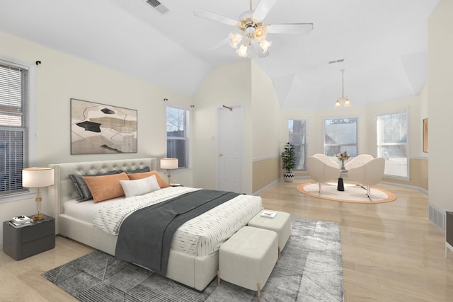 bedroom with lofted ceiling, visible vents, baseboards, a ceiling fan, and light wood finished floors