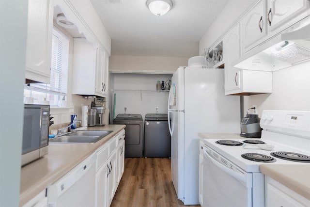 kitchen with white cabinetry, sink, dark hardwood / wood-style flooring, washing machine and clothes dryer, and white appliances