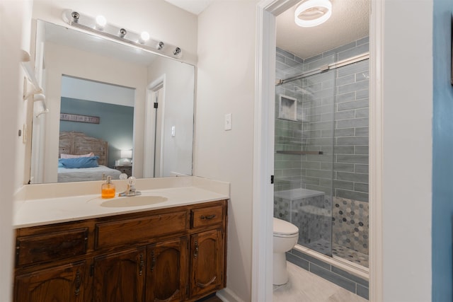 bathroom with walk in shower, vanity, tile patterned floors, and toilet