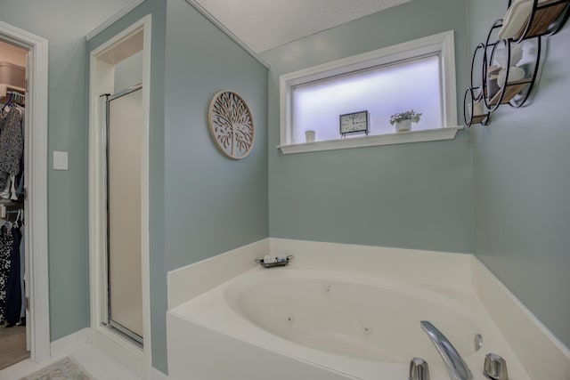 bathroom with independent shower and bath and a textured ceiling