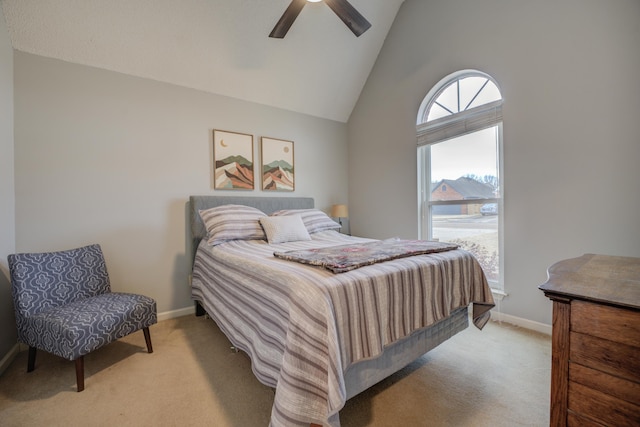 carpeted bedroom with high vaulted ceiling and ceiling fan