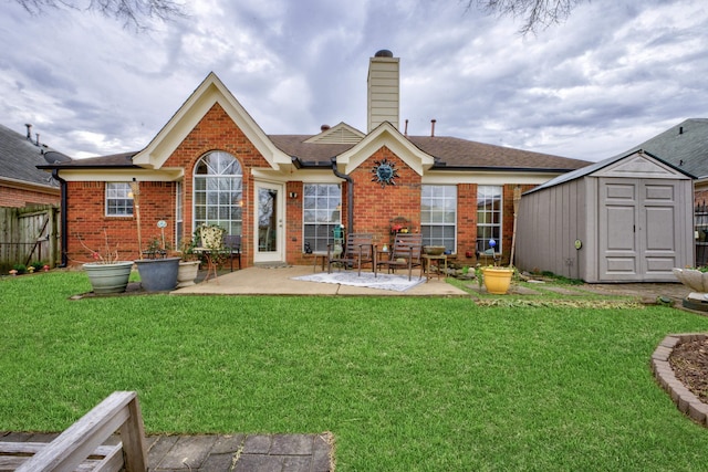 back of house with a yard, a patio area, and a storage unit