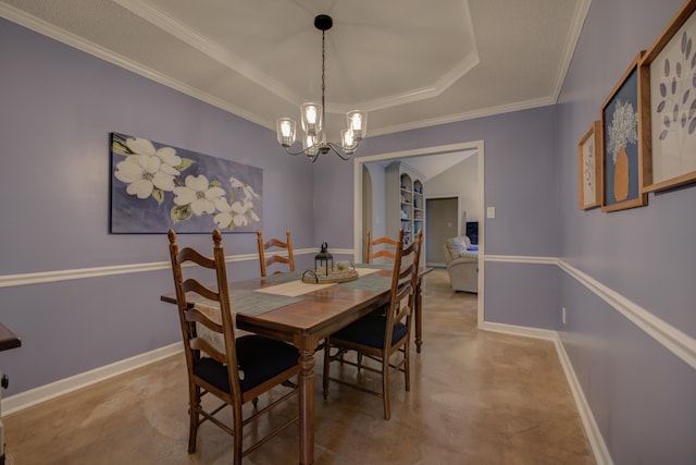 dining area with crown molding, a tray ceiling, a chandelier, and concrete floors