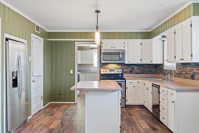 kitchen with stainless steel appliances, white cabinetry, hanging light fixtures, light countertops, and a center island