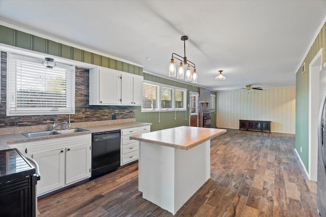 kitchen featuring dishwasher, hanging light fixtures, white cabinetry, and a center island