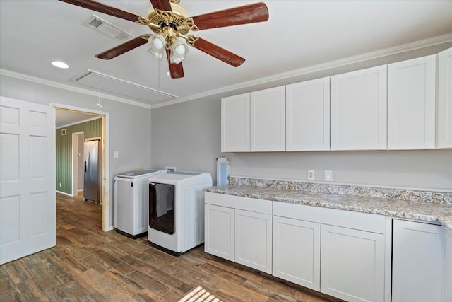 laundry room featuring visible vents, washer and dryer, cabinet space, attic access, and crown molding