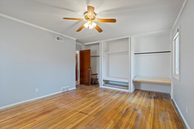 unfurnished bedroom featuring visible vents, crown molding, and light wood finished floors