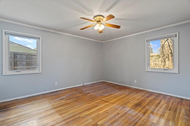 empty room with baseboards, light wood-type flooring, a ceiling fan, and crown molding