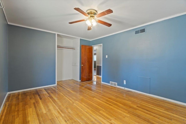 unfurnished bedroom featuring ornamental molding, visible vents, and light wood finished floors