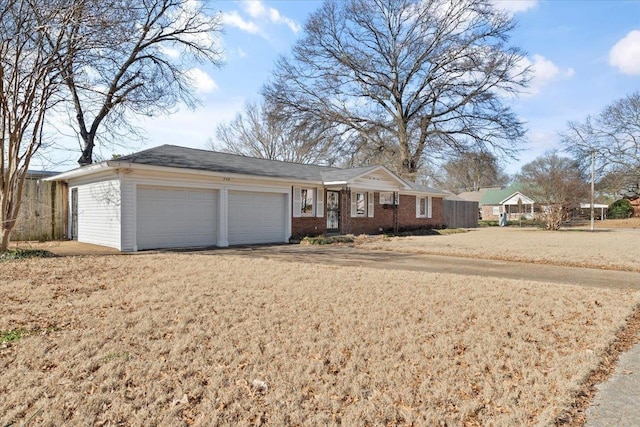 ranch-style home featuring a garage and a front lawn